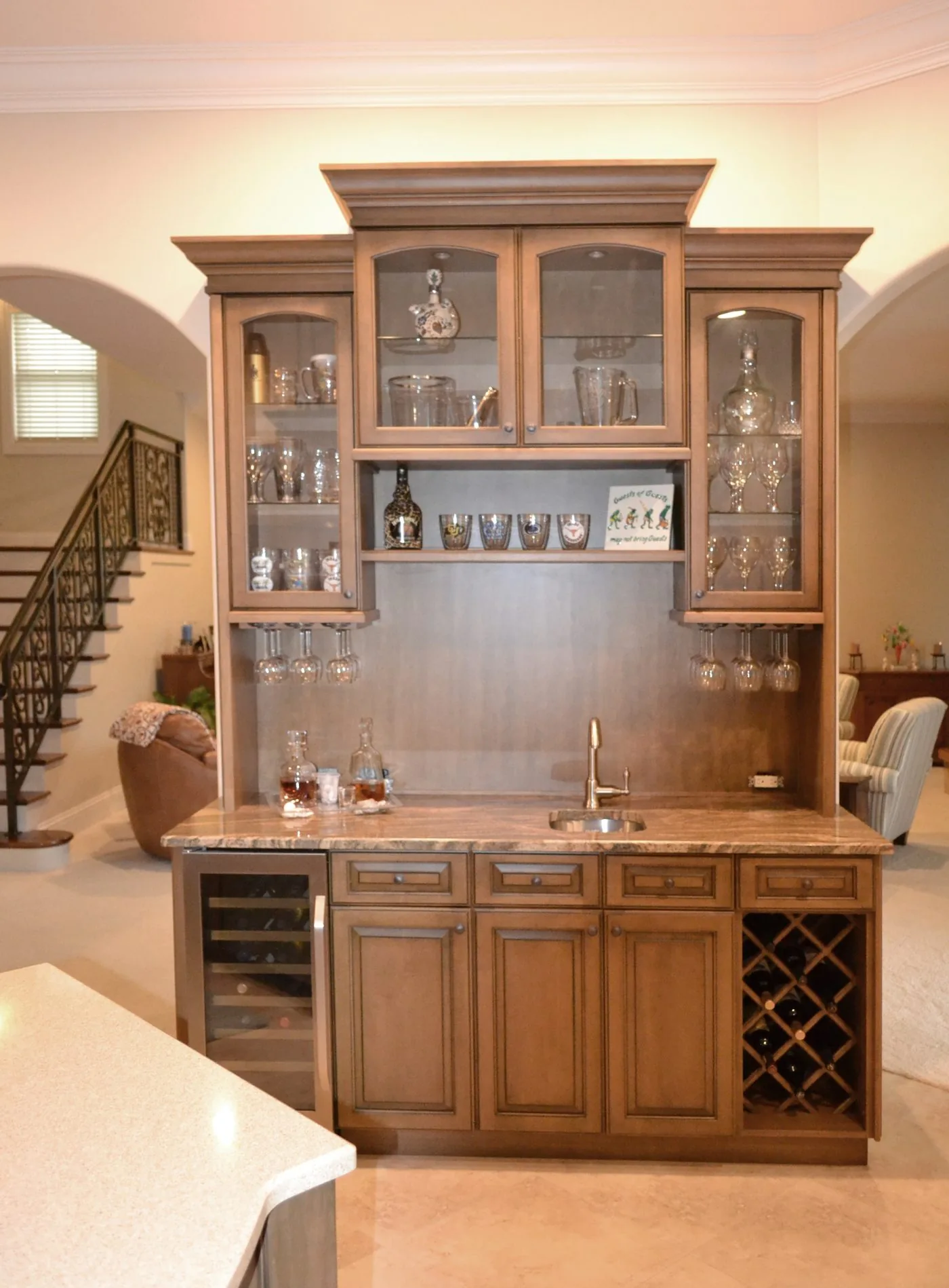 Custom home bar with glass cabinets and wine storage by Elite Woodwork
