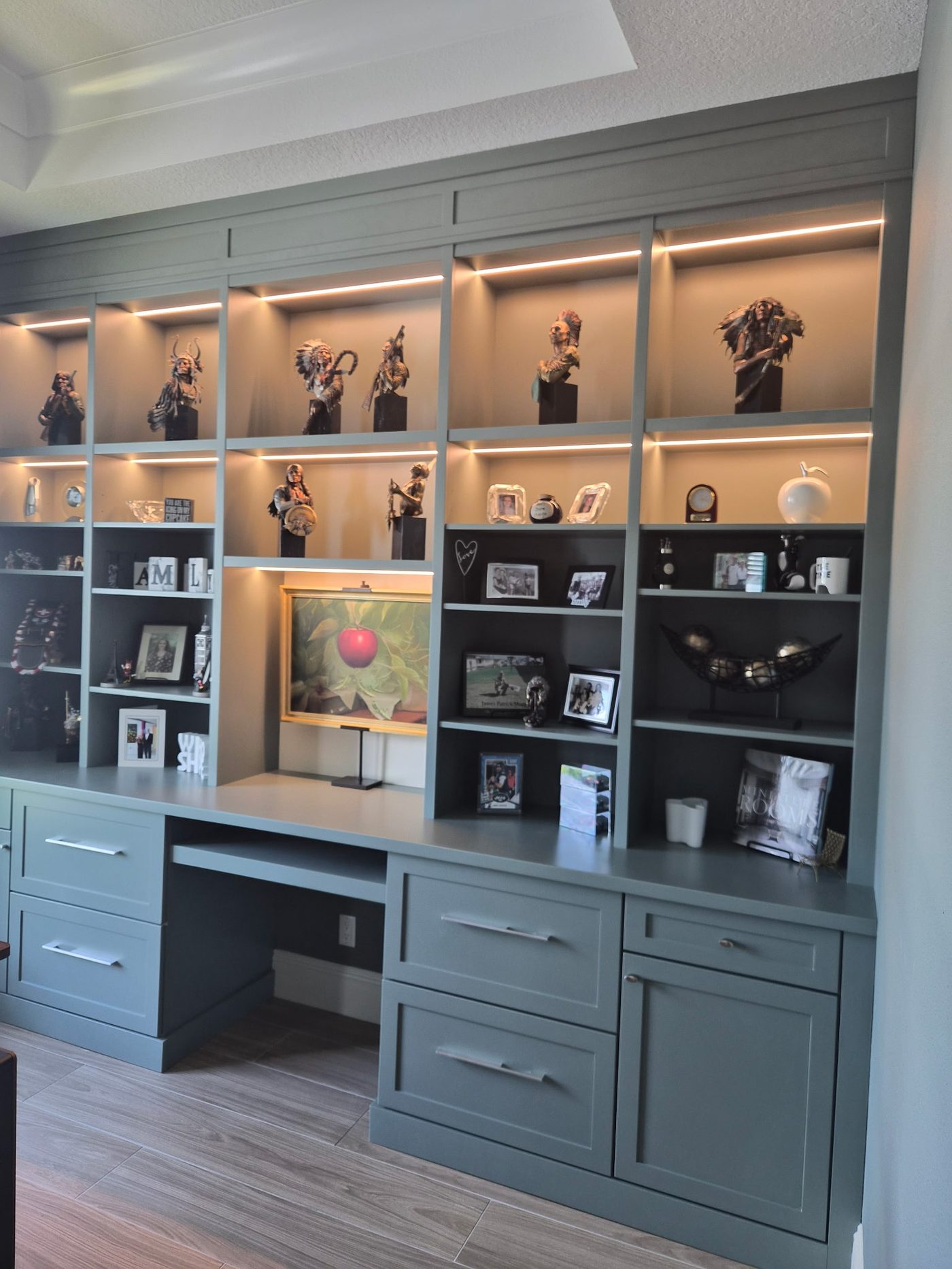 Built-in office wall with lighted display shelving by Elite Woodwork