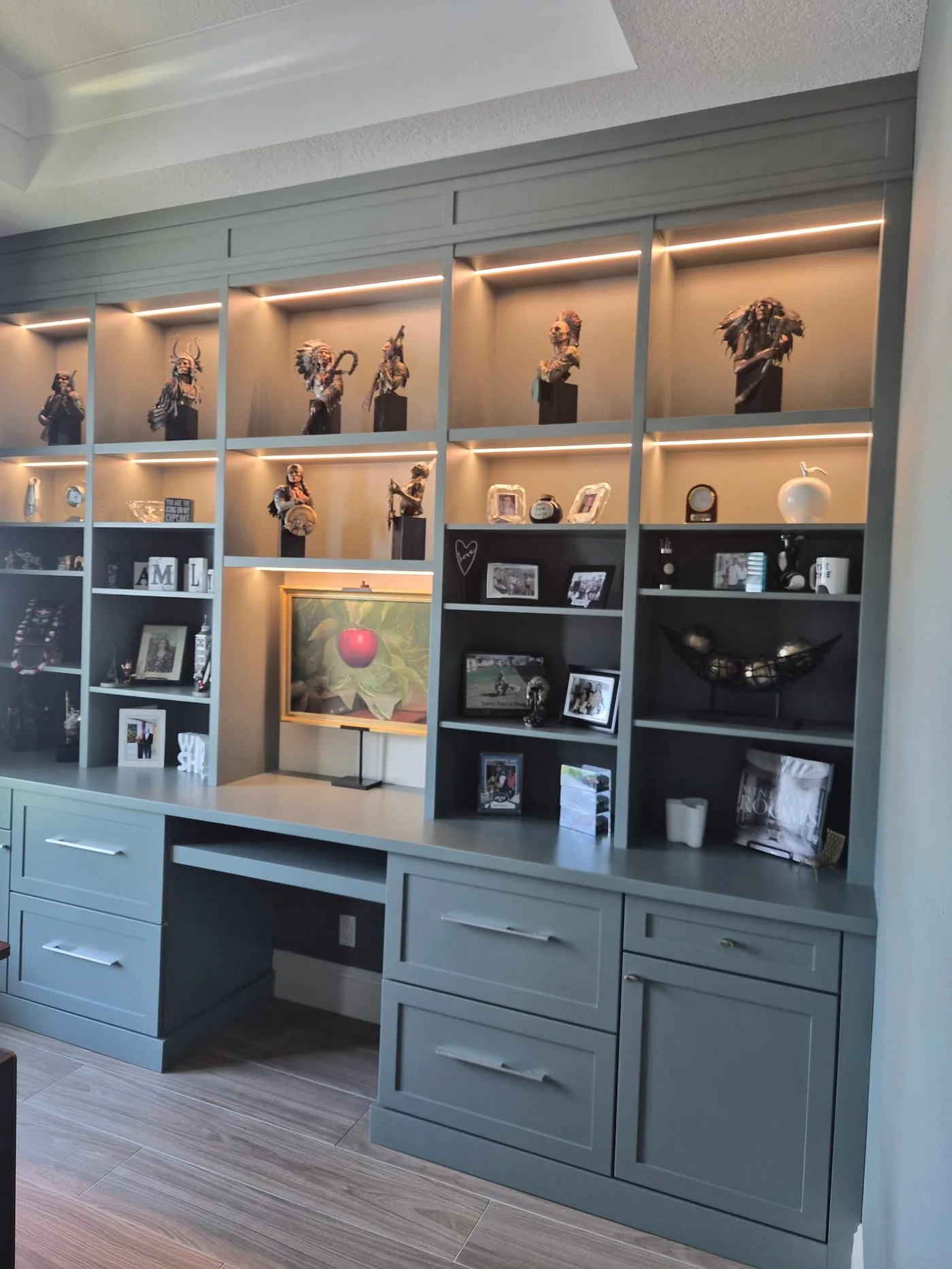 Built-in office wall with lighted display shelving by Elite Woodwork
